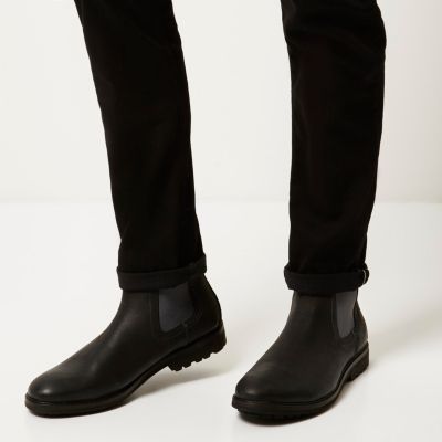 Black leather cleated sole Chelsea boots